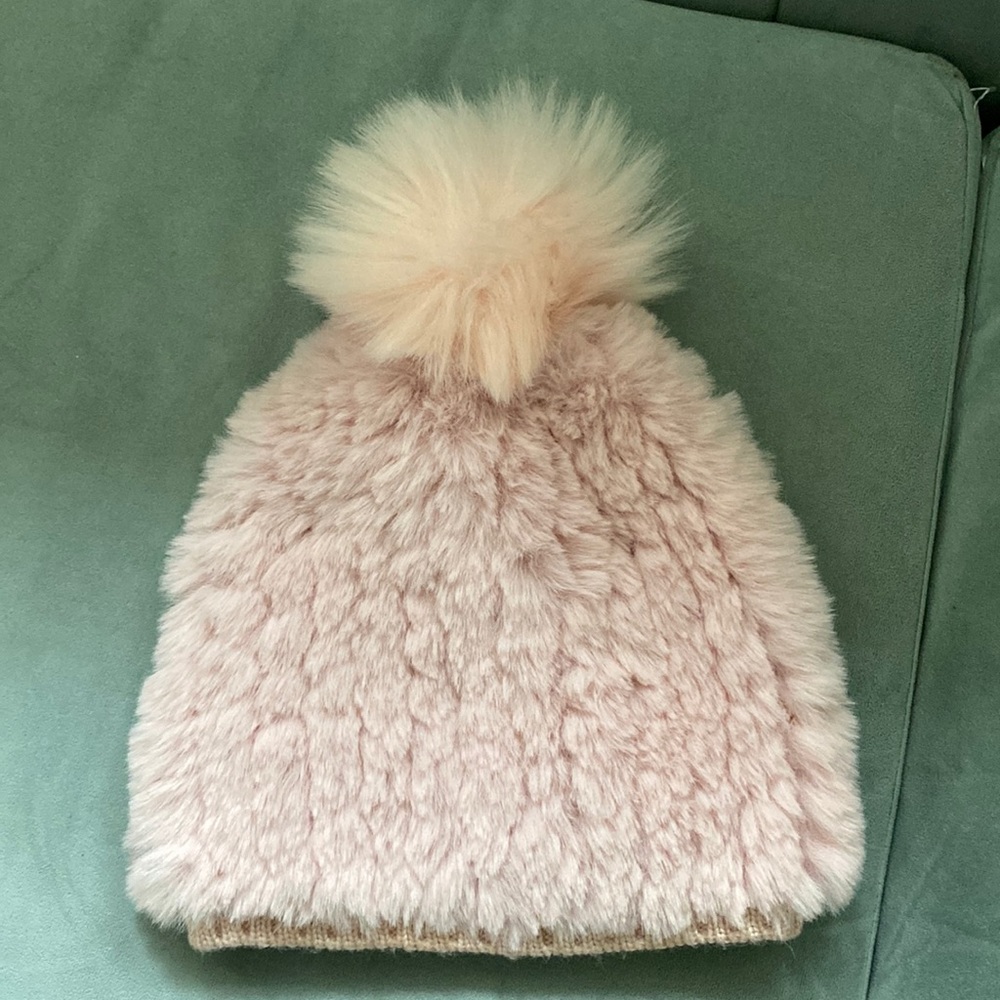 Pink fuzzy hat with ball on top